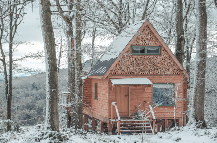 The exterior of Secret Treehouse, Herefordshire in winter with snow