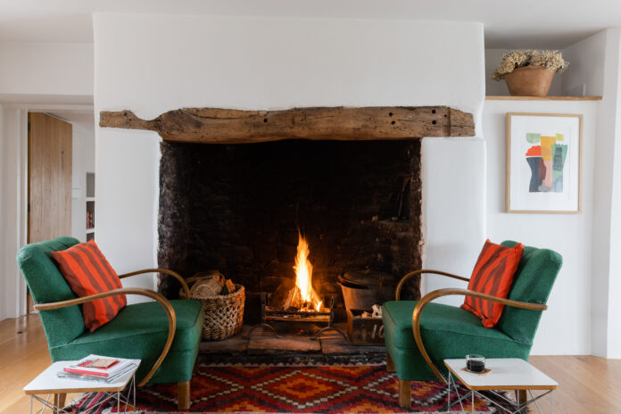 Armchairs next to the fireplace at The Farmhouse, Bude
