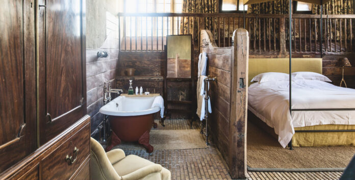 Bathtub and bed at The Riding House, Dorset