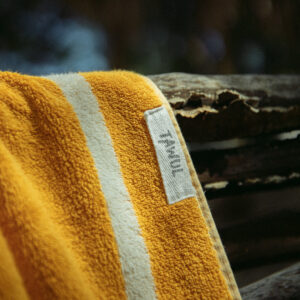 Close up of yellow and cream towel and Tawul Living label