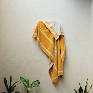 Yellow and cream towel hanging on wall