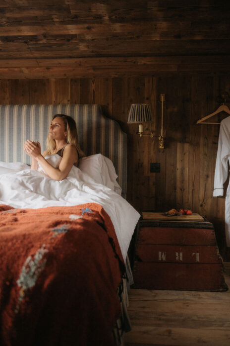 Woman drinking coffee in bed in Chatan, Devon